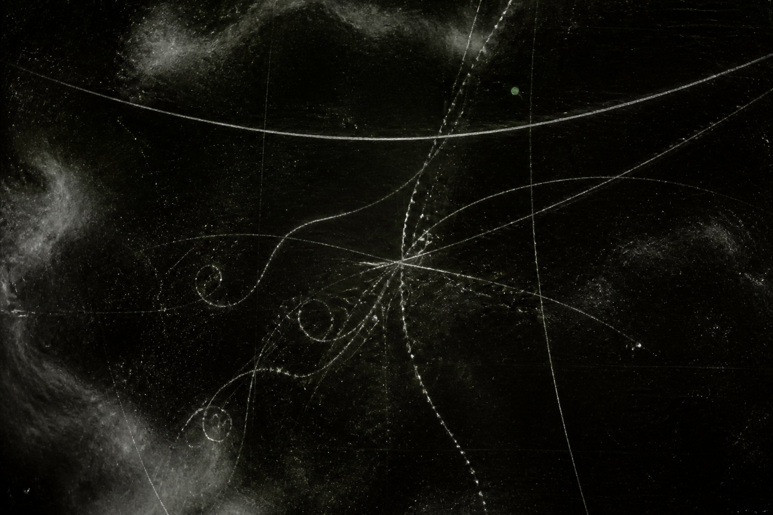 Faint ion path lines on a black photographic plate