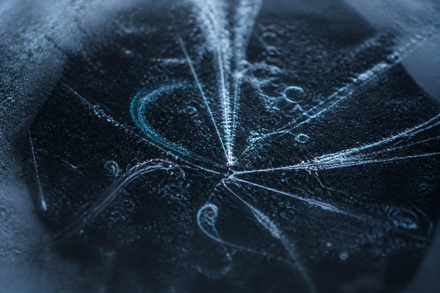 Cold observation glass with condensation streaks and luminous vapor lines